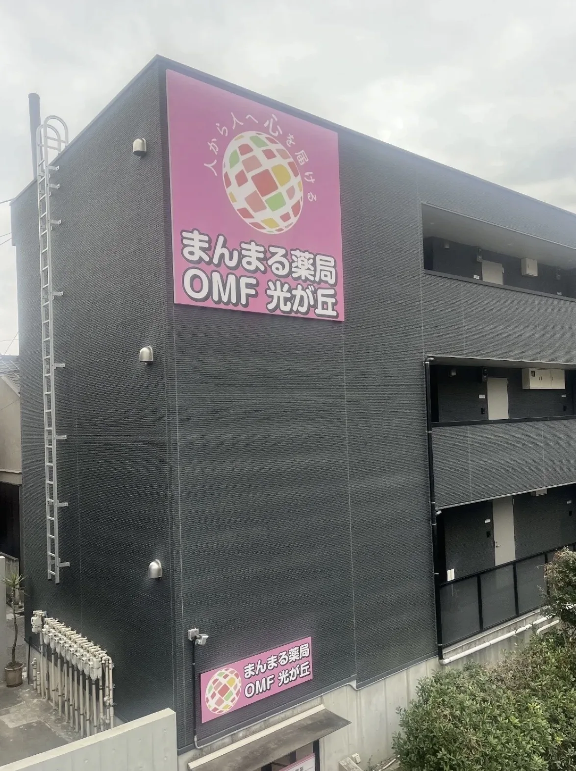 まんまる薬局OMF光が丘の店舗外観 ピンクの大きな看板が目印